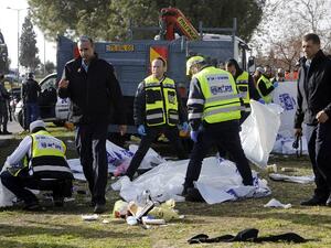 Israeli security forces and emergency personnel gather at the site of a vehicle-ramming attack in Jerusalem on January 8, 2017. (AFP/Menahem Kahana)