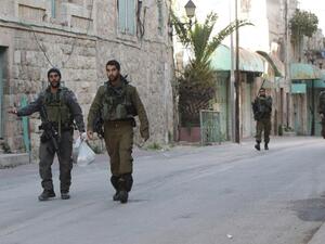 Israeli forces walk through the streets of Hebron, in the West Bank. (AFP/Hazem Bader)