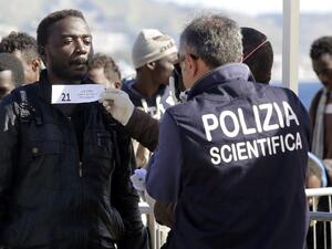 A migrant is logged as he disembarks from a Maltese coast guard patrol vessel after being rescued at sea, on April 15, 2016, at the Messina harbor in Sicily. (AFP/Giovanni Isolino) A migrant is logged as he disembarks from a Maltese coast guard patrol vessel after being rescued at sea, on April 15, 2016, at the Messina harbor in Sicily. (AFP/Giovanni Isolino)