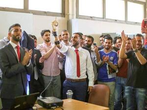 Ahmed Sajdeyya and the prosthetic arm he developed (Facebook)