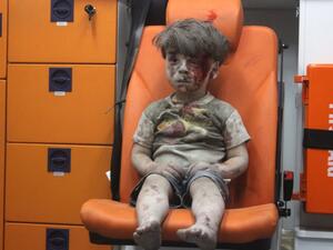 Five-year-old wounded Syrian boy Omran Daqneesh sits alone in the back of an ambulance in Aleppo. (Twitter) 
