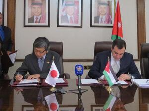 Minister of Planning and International Cooperation Imad Fakhoury signs a loan agreement with Japan’s Ambassador to Jordan Shuichi Sakurai. (Jordan Times)