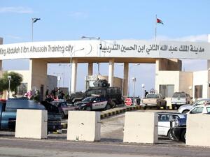 Police officers and security forces stand guard outside a police training center east of Amman on November 9, 2015, where a Jordanian officer shot dead five fellow trainees. (AFP/Stringer)