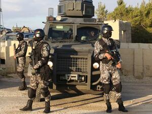 Jordanian security forces are seen on December 19, 2016 during the funeral of victims who were killed a day earlier in an attack at in Karak, around 70 miles south of the capital Amman. (AFP/Khalil Mazraawi) 