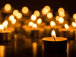 People attend a candle light vigil at the Vilnius Cathedral as it stands unlit during Earth Hour. (AFP/ File Photo)