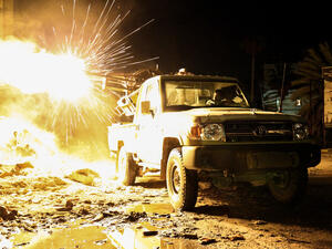 A member of the Libyan National Army, a militia group, fires a machine gun mounted on a pickup truck, Benghazi, 26 March 2017. (AFP/Abdullah Doma)