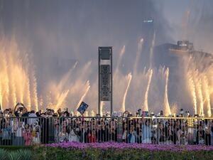 Lareg crowds watch as The Dubai Fountain performs Power by EXO