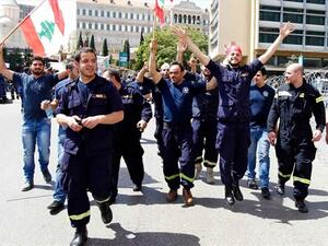 Civil Defense volunteers celebrating the decrees to make them full-time employees. (Image courtesy of The Daily Star)