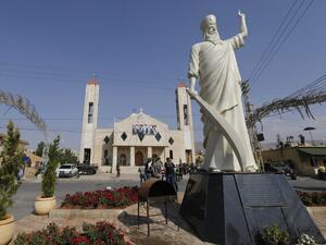 A statute of Saint Elie stands in front of a church where suicide attacks took place earlier this week in the village of al-Qaa, near the country's border with war-ravaged Syria, on June 29, 2016. (AFP/Joseph Eid)