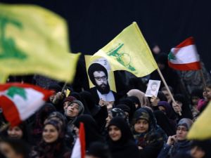 Supporters wave the flag of Lebanon's Shiite movement Hezbollah during a rally held in the southern suburbs of Beirut on February 16, 2016. (AFP/Anwar Amro)