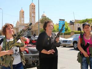 Lebanese Christian women hold weapons as residents of the Christian village of al-Qaa, near the Lebanon's border with war-ravaged Syria, secure the area on June 28, 2016 after two waves of suicide bombings struck the village killing and wounding several people. (AFP/Stringer)