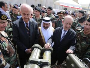 (L to R) Lebanese Army chief Jean General Jean Kahwaji, Lebanese Defende Minister Samir Moqbel, Saudi Ambassador to Lebanon Ali Awad Asiri and French Defende minister Jean-Yves Le Drian take part in a hand-over ceremony of a shipment of Saudi-funded French weapons to the Lebanese Army at Beirut International Airport on 20 April, 2015. (AFP/File)