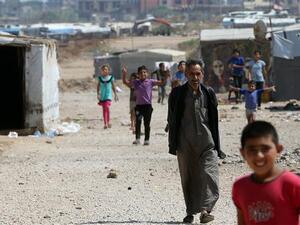 Syrian refugee children walk at an unofficial refugee camp in the area of Arida, north of Lebanon’s capital city of Beirut. (AFP)