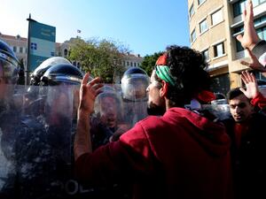 Lebanese demonstrators scuffle with riot police during a protest against the government's decision to raise taxes to cover a salary increase for teachers and other public servants, in downtown Beirut, on March 19, 2017. (AFP/Stringer)