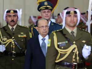 Lebanese President Michel Aoun (C) and Jordan's King Abdullah II (unseen) review the honour guard during an official welcome ceremony at Marka airport in Amman on February 14, 2017. (AFP/Khalil Mazraawi)