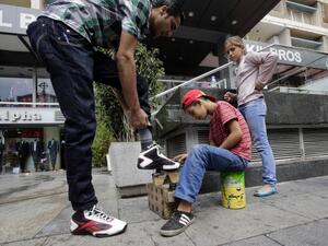 A Syrian child works as a shoe shine in Beirut. (AFP/file)