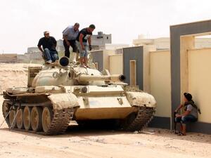 Forces with the National Unity Government stand on a tank in Sirte, Libya, during a land-and-air campaign to retake the city from Daesh. (AFP/Stringer) Forces with the National Unity Government stand on a tank in Sirte, Libya, during a land-and-air campaign to retake the city from Daesh. (AFP/Stringer)
