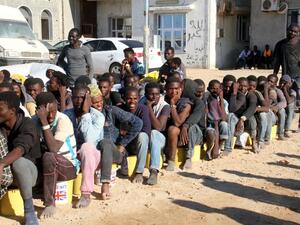 Migrants sit in a port in Tagiura, east of the Libyan capital Tripoli, after 137 people were rescued by coast guard boats off the coast of Libya on July 21, 2016. (AFP/Stringer) Migrants sit in a port in Tagiura, east of the Libyan capital Tripoli, after 137 people were rescued by coast guard boats off the coast of Libya on July 21, 2016. (AFP/Stringer)