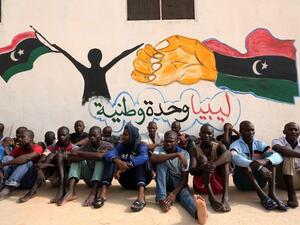 Migrants sit in front of a painted wall on May 19, 2016 at the Abu Salim detention centre in the Libyan capital Tripoli during a visit of United Nations' special envoy to Libya. (AFP/Mahmud Turkia) Migrants sit in front of a painted wall on May 19, 2016 at the Abu Salim detention centre in the Libyan capital Tripoli during a visit of United Nations' special envoy to Libya. (AFP/Mahmud Turkia)