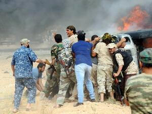 Forces loyal to Libya's UN-backed unity government attempt to evacuate a passenger stuck inside a vehicle following a car-bomb attack carried out by Daesh near Sirte on June 2, 2016. (AFP/Mahmud Turkia) Forces loyal to Libya's UN-backed unity government attempt to evacuate a passenger stuck inside a vehicle following a car-bomb attack carried out by Daesh near Sirte on June 2, 2016. (AFP/Mahmud Turkia)