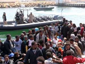 The Libyan coast guard watches over a group of African migrants after towing their boat to the Tripoli shore. (AFP/File) The Libyan coast guard watches over a group of African migrants after towing their boat to the Tripoli shore. (AFP/File)