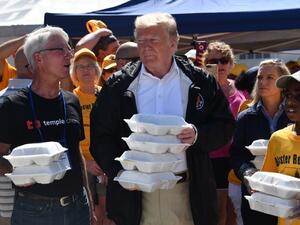 US President Donald Trump greets residents with prepared meals September 19, 2018 in New Bern, North Carolina as he tours areas of the eastern state pummeled by Hurricane Florence. 
Nicholas Kamm / AFP
