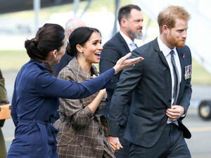 Britain’s Prince Harry and his wife Meghan with New Zealand’s Prime Minister Jacinda Ardern after arriving at the Wellington International Airport Military Terminal in Wellington. (Source: AFP)