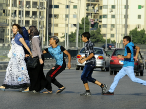 Young boys harass a group of women.
