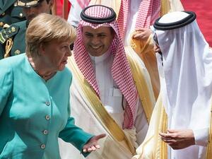 A handout picture provided by the Saudi Royal Palace shows German Chancellor Angela Merkel (L) chatting with Saudi Arabia’s King Salman (R) during a welcome ceremony in Riyadh on April 30, 2017. (AFP/ Bandar Al-Jaloud)