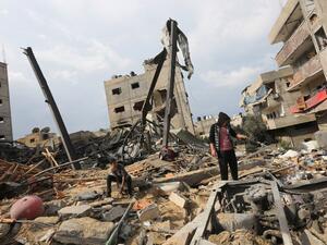 A Palestinian stands amidst the rubble of the building housing the Hamas-run television station al-Aqsa TV, destroyed by an Israeli airstrike. (MAHMUD HAMS / AFP)