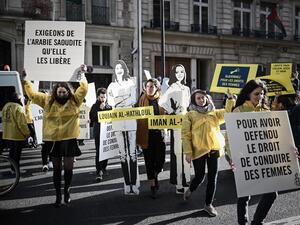 Women's rights activists hold signs as they take part in a demonstration organized by Amnesty International outside the Saudi Arabia embassy in Paris, on March 8, 2019 during International Women's Day. (AFP)
