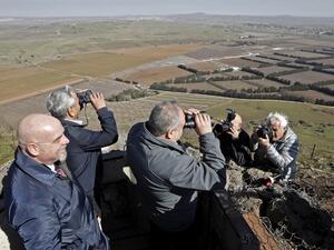 Avigdor Lieberman, Yisrael Beiteinu party leader and Israel's former defence minister, looks through binoculars during a visit to a looking point in Mount Bental in the Israeli-annexed Golan Heights. (AFP)