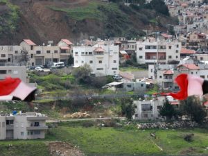 Syrian national flags are flown in the Syrian town Ain al-Tineh across from Majdal Shams in the Israeli-annexed Golan Heights on March 26, 2019. (Louai Beshara / AFP)