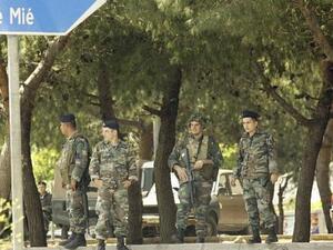 Soldiers stand guard on the road leading to Mieh Mieh Palestinian refugee camp. (AFP/ File Photo)