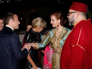 The French president is welcomed by King Mohammed VI and his wife, Princess Lala Salma. (AFP) 