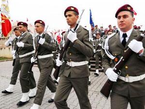 Tunisian troops takes part in an official ceremony marking the third anniversary of the uprising that ousted long-time dictator Zine El Abidine Ben Ali on Tuesday in Tunis. [AFP]