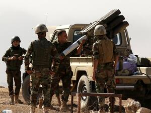 Iraqi forces load artillery outside Mosul. (AFP/File)