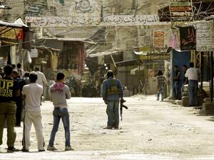Fighters are seen along a street in the Ain al-Helweh Palestinian refugee camp on the outskirts of the southern Lebanese city of Sidon, on 12 March 2013, after one person was killed and several wounded in clashes that erupted in the camp. (AFP/Mahmoud Zayyat)