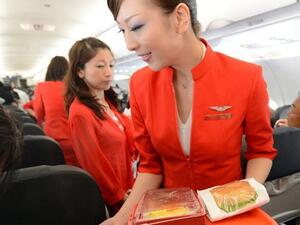 Up in the air: Air Asia Japan's cabin attendants provide the in-flight meal. (AFP/File)