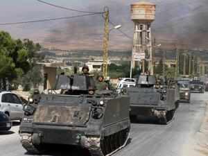 Lebanese army soldiers drive armoured personnel carriers in the northern Lebanese town of Arsal on the border with Syria on August 6, 2014. (AFP/File)