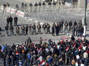 Iraqi security forces stand guard as supporters of the Sadrist movement gather during a demonstration in Baghdad. (AFP/File)