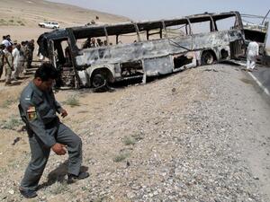 In April 2013 a bus hit a wrecked fuel tanker in the southern province of Kandahar. (AFP/File) In April 2013 a bus hit a wrecked fuel tanker in the southern province of Kandahar. (AFP/File)