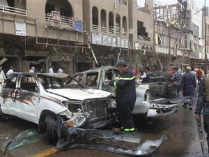 Rescue teams and security forces inspect the site of a car bomb blast in Baghdad's centre. (AFP/File)