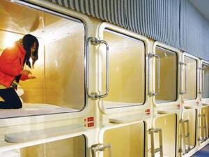 A woman trying out a cabinet-sized room at China's first capsule hotel in Shanghai. (AFP/File)
