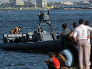 Egyptian rescue workers arrive on a boat carrying bodies of migrants in Rosetta, Egypt, on Friday after a boat carrying migrants capsized in the Mediterranean. (AFP/File)