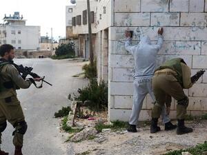 Occupation forces inspect a young Palestinian. (AFP/File)