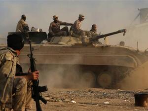 Members of the Iraqi forces drive a BMP-1 infantry fighting vehicle as they hold a position in the village of Jarif, some 45 kilometers south of Mosul, on November 12, 2016, after retaking it from Daesh. (AFP/File)