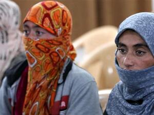 Izadi women look on at al-Tun Kopri health centre, located half way between the northern Iraqi city of Kirkuk and Arbil, after ISIL released them with around 200 mostly elderly members of Iraq's Izadi minority near Kirkuk on January 17, 2015. (AFP/File)