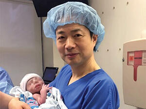 Doctor John Zhang holds the world's first baby with three genetic parents. (Courtesy photo)