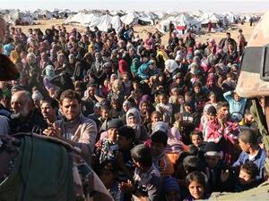 The photo shows Syrian refugees, stuck on the Jordanian- Syrian border, waiting to cross into Jordan, at the Hadalat border crossing on January 14, 2016. (AFP/File)